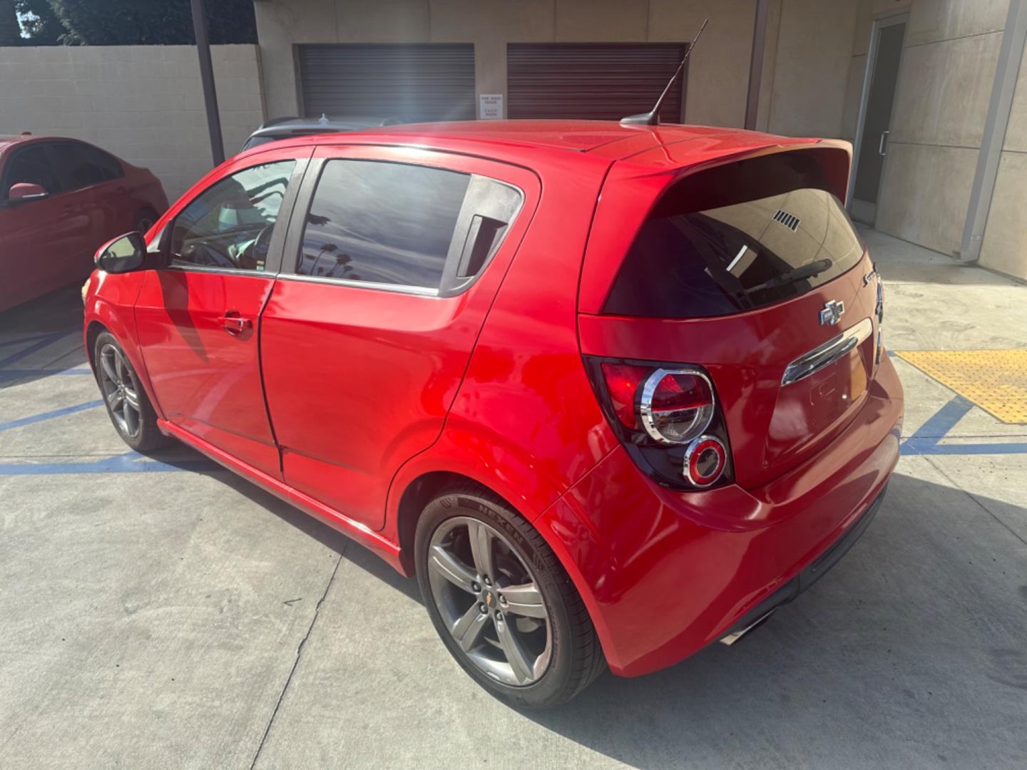 2013 Red /Black Chevrolet Sonic Cloth (1G1JG6SB3D4) with an 4 CYLINDER engine, Automatic transmission, located at 30 S. Berkeley Avenue, Pasadena, CA, 91107, (626) 248-7567, 34.145447, -118.109398 - The 2013 Chevrolet Sonic RS Auto 5-Door is a standout choice for drivers seeking a blend of style, performance, and practicality. At our Pasadena, CA dealership, we specialize in offering a wide array of used BHPH (Buy Here Pay Here) cars, including the dynamic Chevrolet Sonic RS. This detailed guid - Photo#2